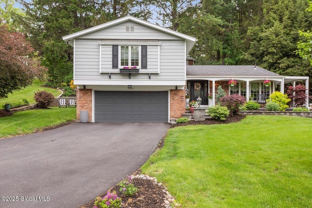 1335 Stanley Ln, Niskayuna, NY 12309 - tri-level home with driveway, a garage, a front lawn, and brick siding