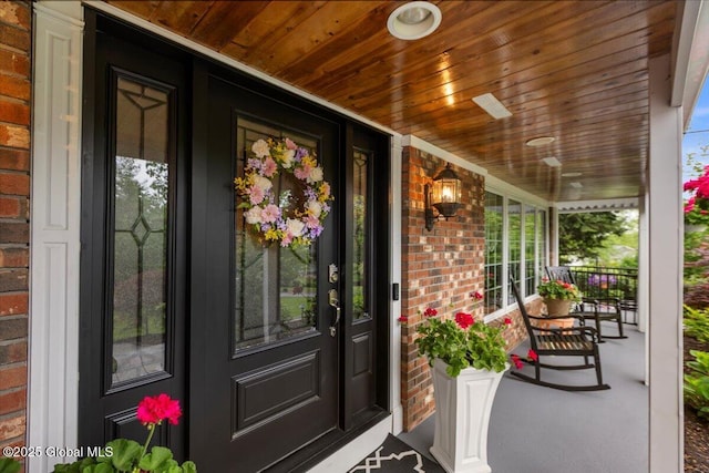 1335 Stanley Ln, Niskayuna, NY 12309 - doorway to property featuring covered porch and brick siding