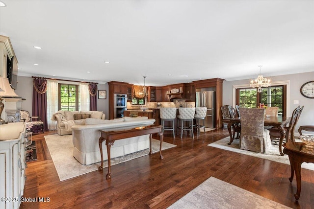 1335 Stanley Ln, Niskayuna, NY 12309 - living area featuring a chandelier, wood finished floors, ornamental molding, and recessed lighting
