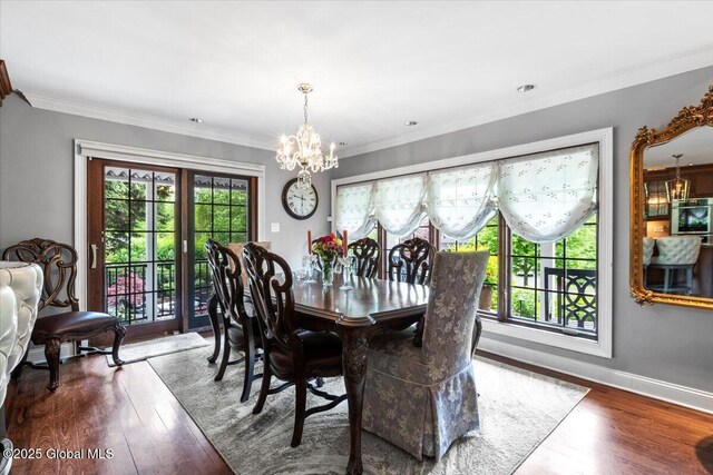 1335 Stanley Ln, Niskayuna, NY 12309 - dining area featuring a chandelier, wood finished floors, ornamental molding, and baseboards