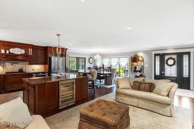 1335 Stanley Ln, Niskayuna, NY 12309 - living area featuring wine cooler, ornamental molding, a chandelier, light wood-type flooring, and recessed lighting