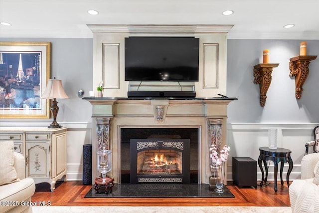 1335 Stanley Ln, Niskayuna, NY 12309 - detailed view of a warm lit fireplace, wood finished floors, crown molding, and recessed lighting