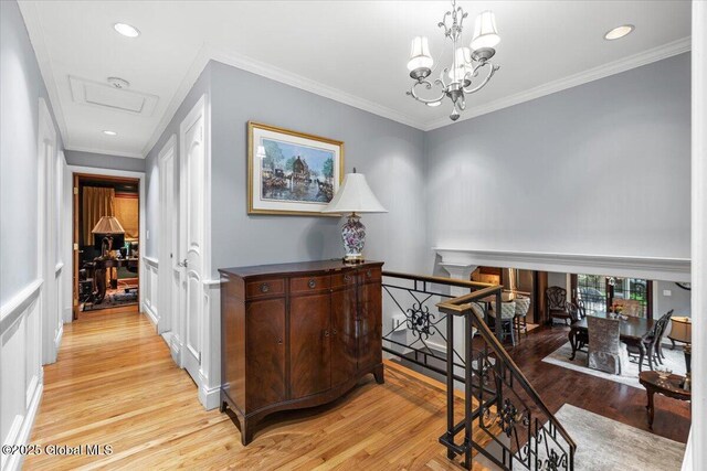 1335 Stanley Ln, Niskayuna, NY 12309 - corridor featuring light wood finished floors, an upstairs landing, a chandelier, recessed lighting, and ornamental molding