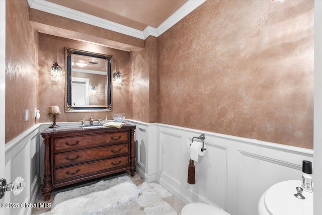 1335 Stanley Ln, Niskayuna, NY 12309 - half bath featuring toilet, a decorative wall, vanity, ornamental molding, and wainscoting