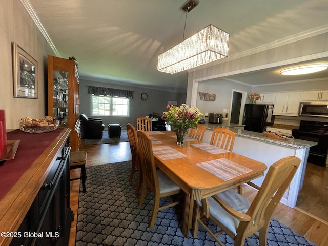 17 Sylvan Ln, Clifton Park, NY 12065 - dining area with dark wood finished floors, a chandelier, and crown molding