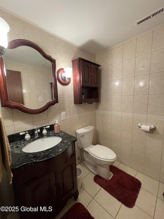 17 Sylvan Ln, Clifton Park, NY 12065 - bathroom with vanity, tile patterned floors, tile walls, toilet, and decorative backsplash