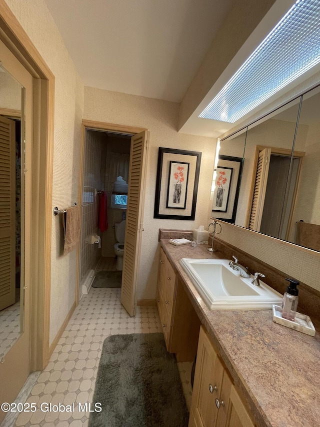 17 Sylvan Ln, Clifton Park, NY 12065 - full bathroom with double vanity, tile patterned floors, toilet, and baseboards