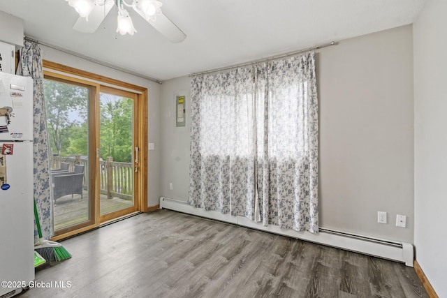 13 Willow Ln, Halfmoon, NY 12118 - empty room featuring wood finished floors, a ceiling fan, and baseboard heating