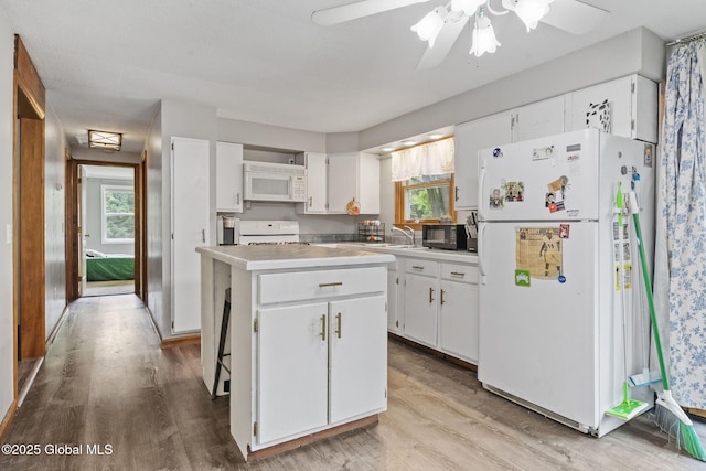 13 Willow Ln, Halfmoon, NY 12118 - kitchen featuring white appliances, a center island, light wood-style flooring, white cabinetry, and ceiling fan