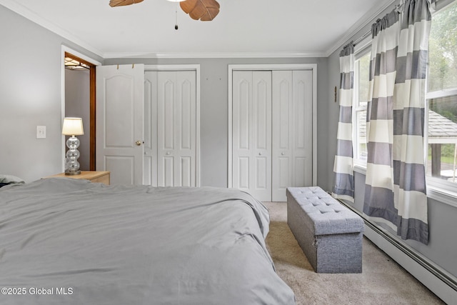 13 Willow Ln, Halfmoon, NY 12118 - bedroom with baseboard heating, light colored carpet, crown molding, two closets, and multiple windows