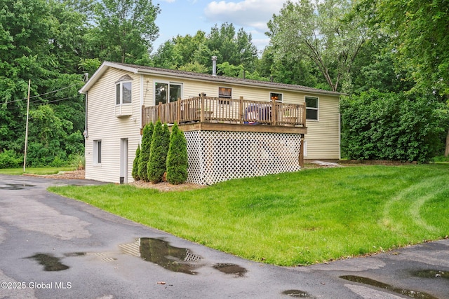13 Willow Ln, Halfmoon, NY 12118 - view of front of house with a wooden deck, a front lawn, and view of scattered trees