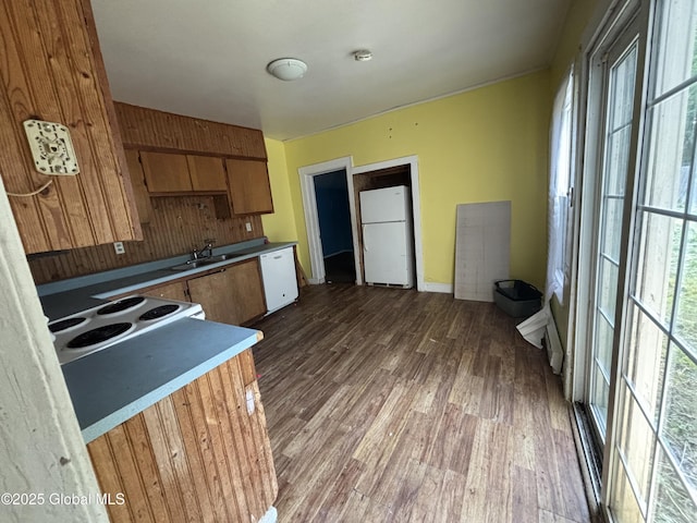207 Fon Clair St, Johnstown, NY 12095 - kitchen with white appliances, wood finished floors, and brown cabinets