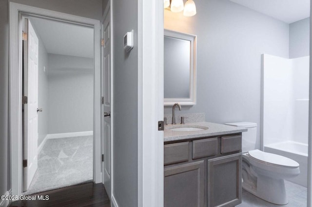 30 W St, Hudson Falls, NY 12839 - full bathroom featuring vanity, toilet, shower / tub combination, wood finished floors, and baseboards