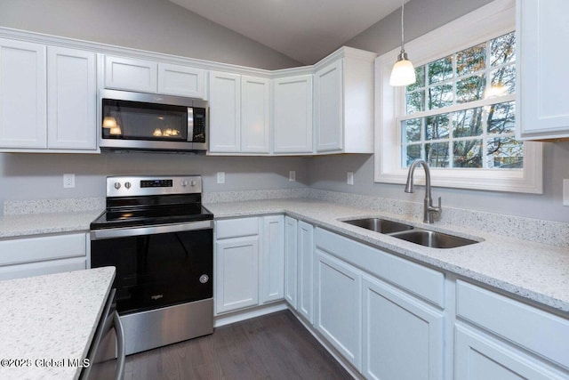 30 W St, Hudson Falls, NY 12839 - kitchen with appliances with stainless steel finishes, a sink, vaulted ceiling, and white cabinets