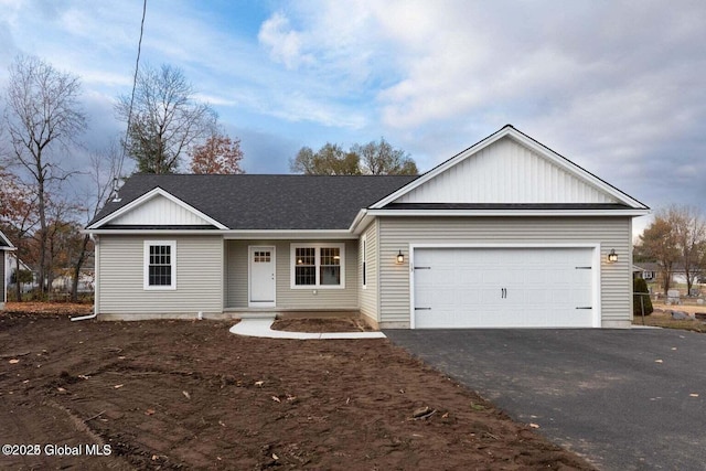 30 W St, Hudson Falls, NY 12839 - single story home with asphalt driveway, a garage, and a shingled roof