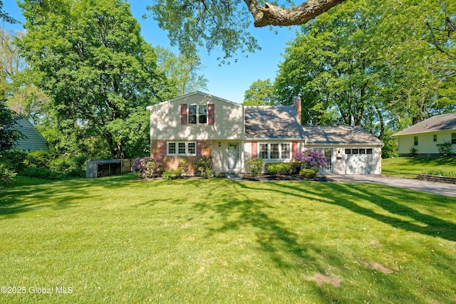 9 S Maple Ln, Colonie, NY 12211 - view of front facade with asphalt driveway, a chimney, a garage, and a front yard