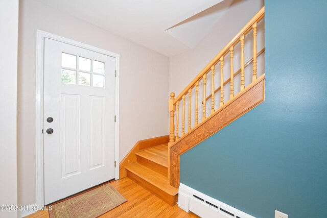 9 S Maple Ln, Colonie, NY 12211 - foyer with stairs, wood finished floors, a baseboard heating unit, and baseboards