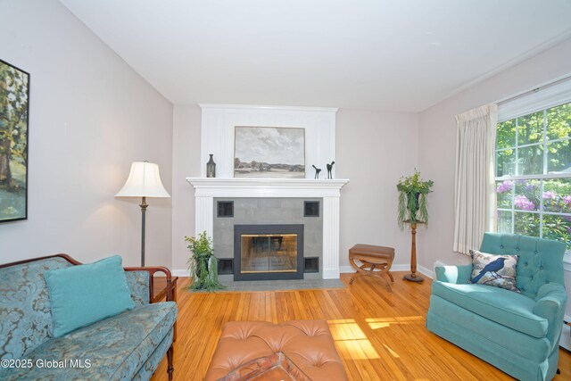 9 S Maple Ln, Colonie, NY 12211 - living area featuring a tile fireplace, wood finished floors, and baseboards
