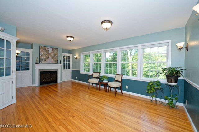 9 S Maple Ln, Colonie, NY 12211 - living area featuring light wood finished floors, baseboards, and a fireplace with flush hearth
