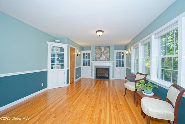 9 S Maple Ln, Colonie, NY 12211 - living room with light wood-style flooring, a fireplace with flush hearth, and baseboards