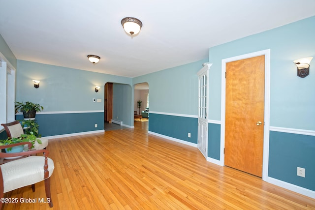 9 S Maple Ln, Colonie, NY 12211 - unfurnished room featuring arched walkways, light wood-style flooring, and baseboards