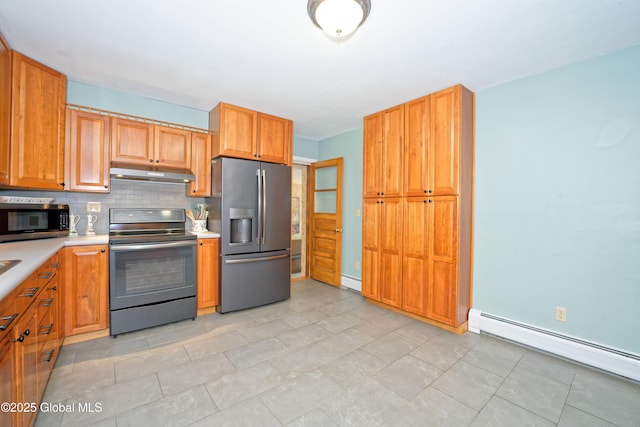 9 S Maple Ln, Colonie, NY 12211 - kitchen with stainless steel appliances, under cabinet range hood, light countertops, a baseboard radiator, and decorative backsplash
