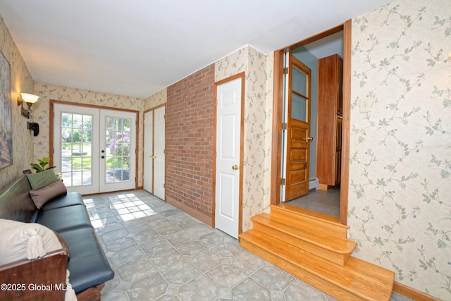 9 S Maple Ln, Colonie, NY 12211 - living room with wallpapered walls, french doors, and a baseboard heating unit