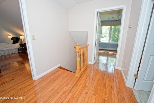 9 S Maple Ln, Colonie, NY 12211 - hallway featuring an upstairs landing, a baseboard radiator, light wood-style flooring, lofted ceiling, and baseboards