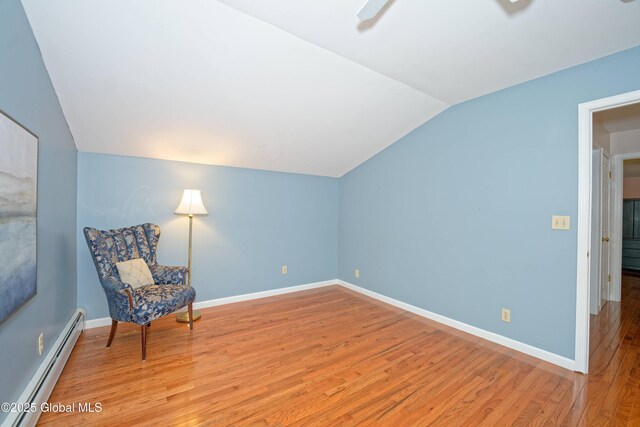 9 S Maple Ln, Colonie, NY 12211 - unfurnished room featuring a baseboard radiator, vaulted ceiling, light wood finished floors, baseboards, and ceiling fan