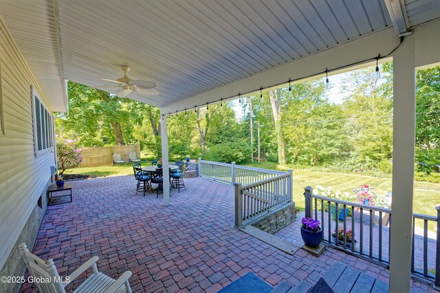 9 S Maple Ln, Colonie, NY 12211 - view of patio with outdoor dining area, ceiling fan, and view of wooded area