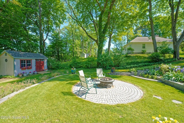 9 S Maple Ln, Colonie, NY 12211 - view of green lawn with a fire pit and a patio