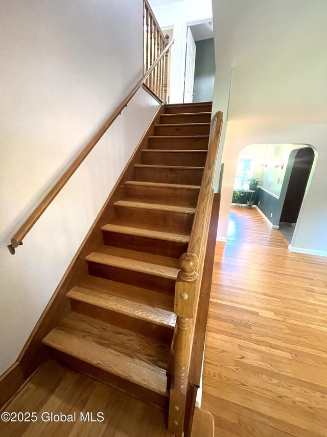 9 S Maple Ln, Colonie, NY 12211 - stairway featuring wood finished floors, arched walkways, and baseboards