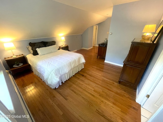 9 S Maple Ln, Colonie, NY 12211 - bedroom with wood finished floors, baseboards, and lofted ceiling