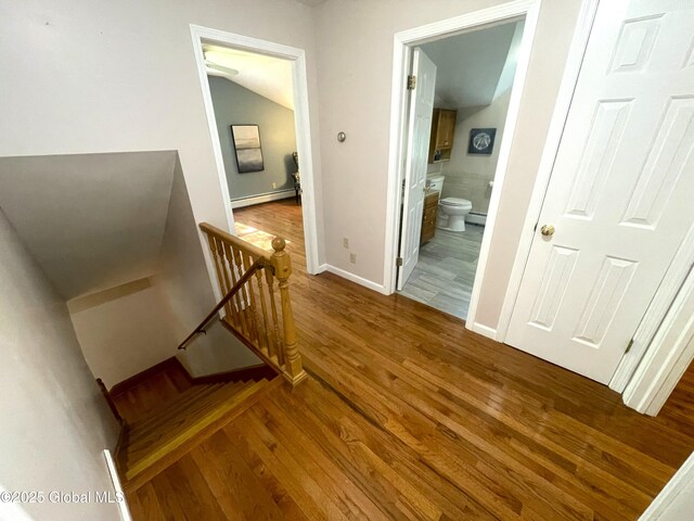 9 S Maple Ln, Colonie, NY 12211 - stairway with a baseboard radiator, wood finished floors, baseboards, and vaulted ceiling