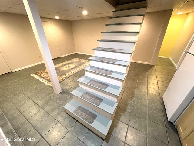 9 S Maple Ln, Colonie, NY 12211 - finished below grade area with a drop ceiling, baseboards, tile patterned floors, recessed lighting, and refrigerator