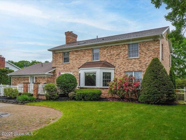 3077 New Williamsburg Dr, Guilderland, NY 12303 - rear view of property featuring a chimney and brick siding