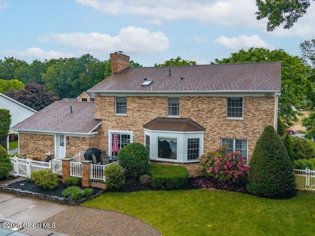 3077 New Williamsburg Dr, Guilderland, NY 12303 - view of front of house with a chimney, a shingled roof, a gate, and brick siding