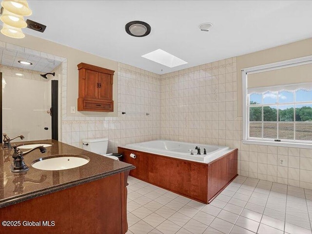 3077 New Williamsburg Dr, Guilderland, NY 12303 - full bath with tile walls, a skylight, tile patterned flooring, a garden tub, and vanity