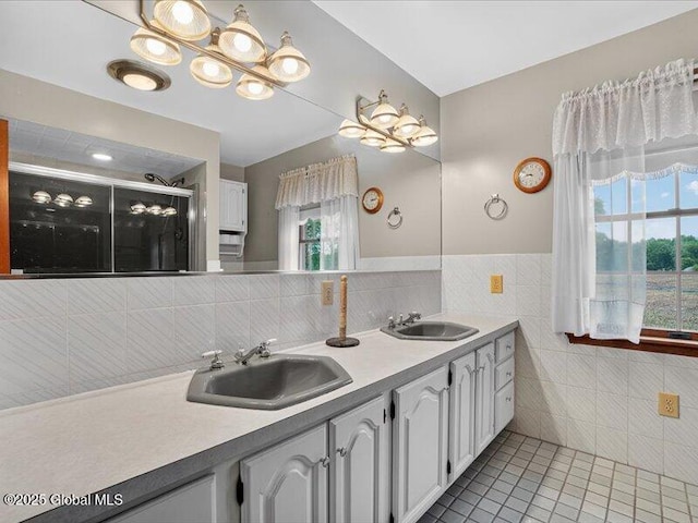 3077 New Williamsburg Dr, Guilderland, NY 12303 - bathroom featuring tile patterned flooring, tile walls, double vanity, a stall shower, and a wainscoted wall