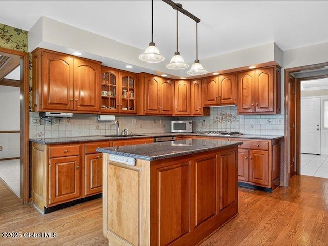3077 New Williamsburg Dr, Guilderland, NY 12303 - kitchen featuring stainless steel appliances, brown cabinets, and light wood-style flooring
