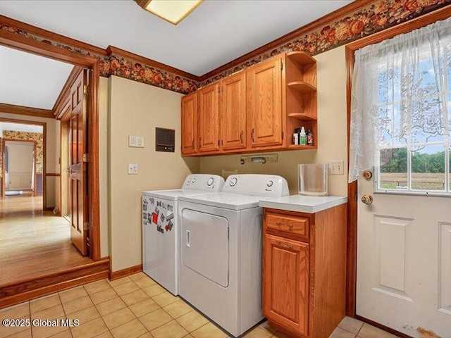 3077 New Williamsburg Dr, Guilderland, NY 12303 - washroom with cabinet space, washing machine and clothes dryer, light tile patterned flooring, and ornamental molding