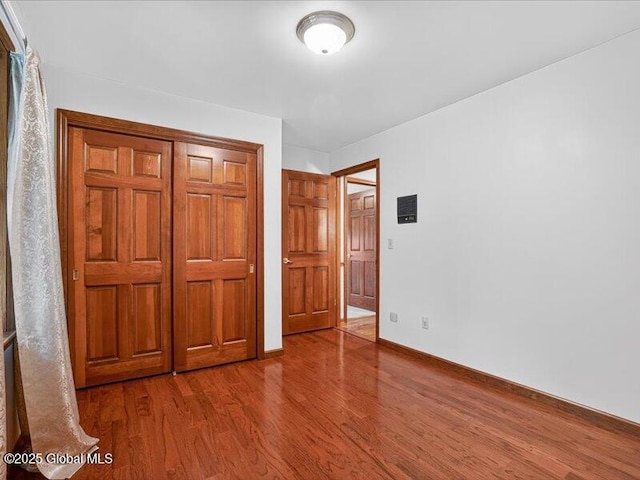 3077 New Williamsburg Dr, Guilderland, NY 12303 - unfurnished bedroom with wood finished floors and a closet