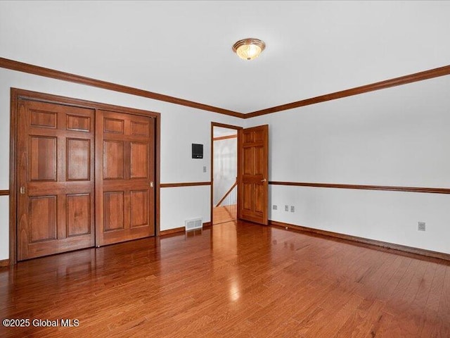 3077 New Williamsburg Dr, Guilderland, NY 12303 - empty room with wood finished floors and crown molding