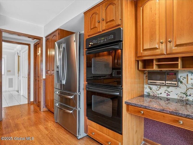 3077 New Williamsburg Dr, Guilderland, NY 12303 - kitchen featuring stainless steel refrigerator with ice dispenser, brown cabinetry, light wood-style flooring, dark stone countertops, and ornamental molding