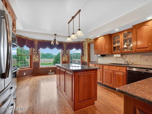 3077 New Williamsburg Dr, Guilderland, NY 12303 - kitchen featuring dishwashing machine, wood finished floors, brown cabinetry, glass insert cabinets, and recessed lighting