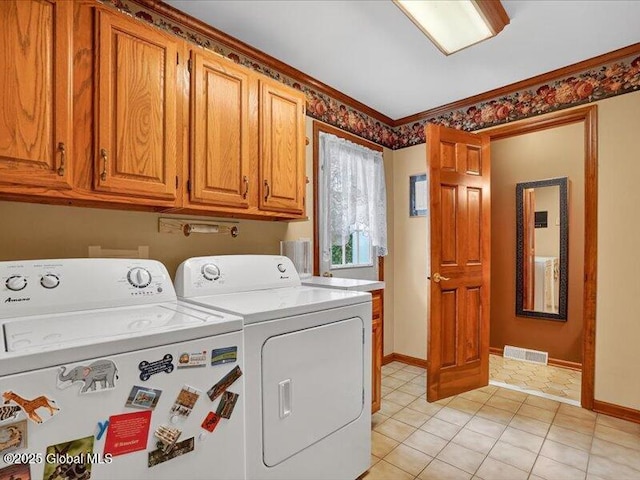 3077 New Williamsburg Dr, Guilderland, NY 12303 - laundry area with washing machine and dryer, cabinet space, crown molding, and light tile patterned floors