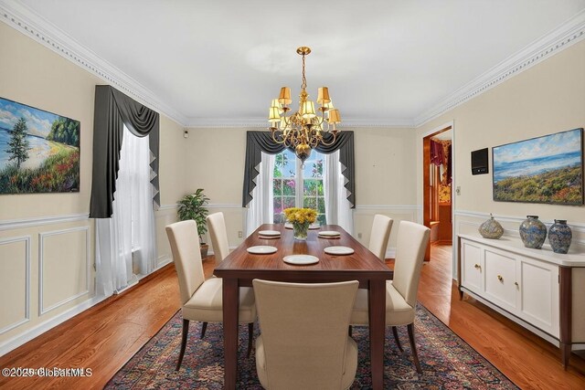 3077 New Williamsburg Dr, Guilderland, NY 12303 - dining space featuring a chandelier, ornamental molding, light wood-style floors, a decorative wall, and a wainscoted wall