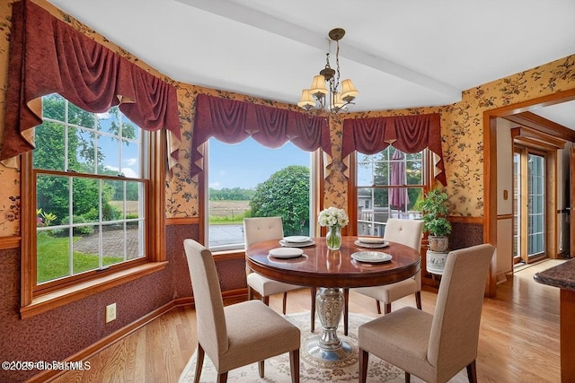 3077 New Williamsburg Dr, Guilderland, NY 12303 - dining space with wallpapered walls, a chandelier, and light wood-type flooring