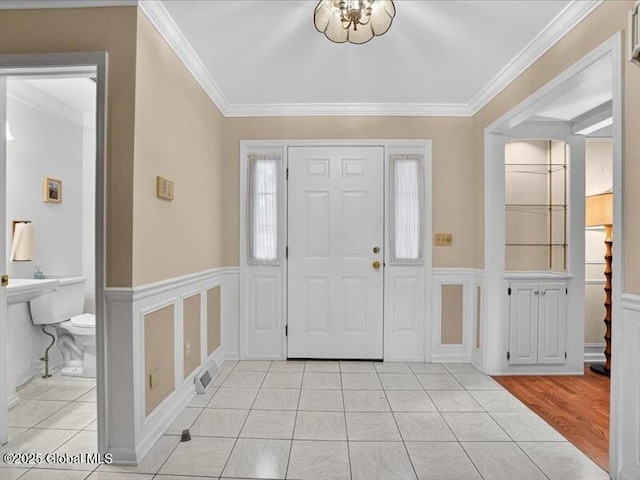 3077 New Williamsburg Dr, Guilderland, NY 12303 - entrance foyer with crown molding and a wainscoted wall