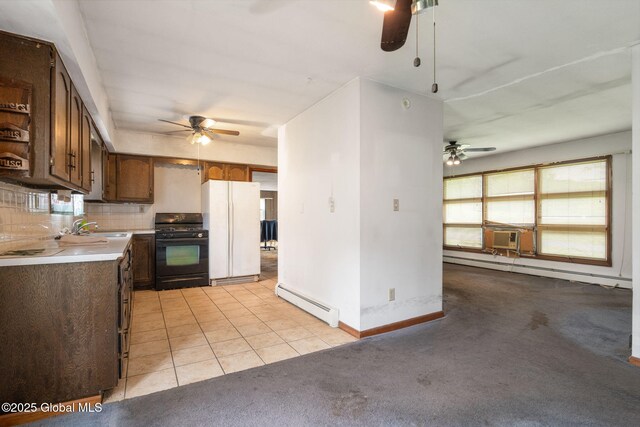 195 N St, Cobleskill, NY 12043 - kitchen with black gas stove, baseboard heating, freestanding refrigerator, and a ceiling fan
